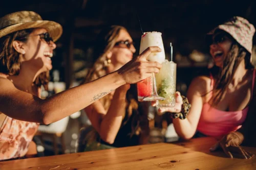 A group of friends having fun at the Sandbar at the Sanderling Hotel, enjoying vibrant and freshly prepared cocktails.