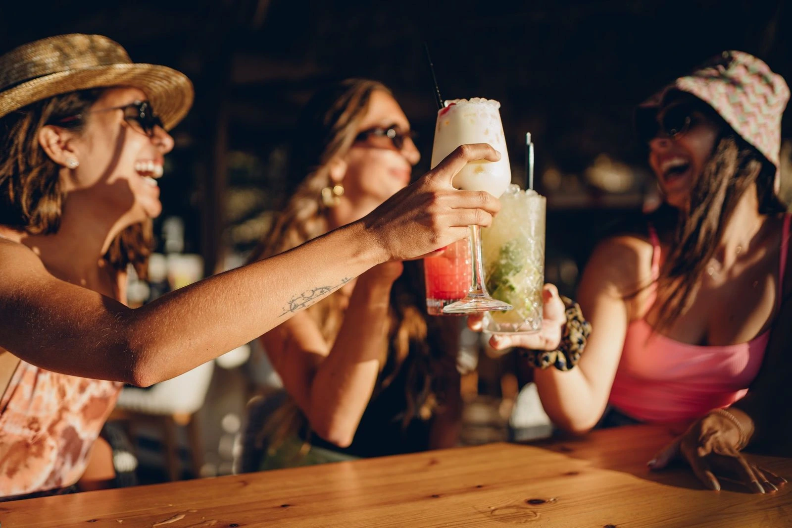 A group of friends having fun at the Sandbar at the Sanderling Hotel, enjoying vibrant and freshly prepared cocktails.
