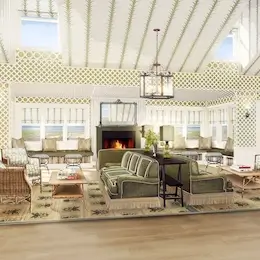 Cozy lounge with a fireplace, large sofas, and rugs, perfect for relaxing.