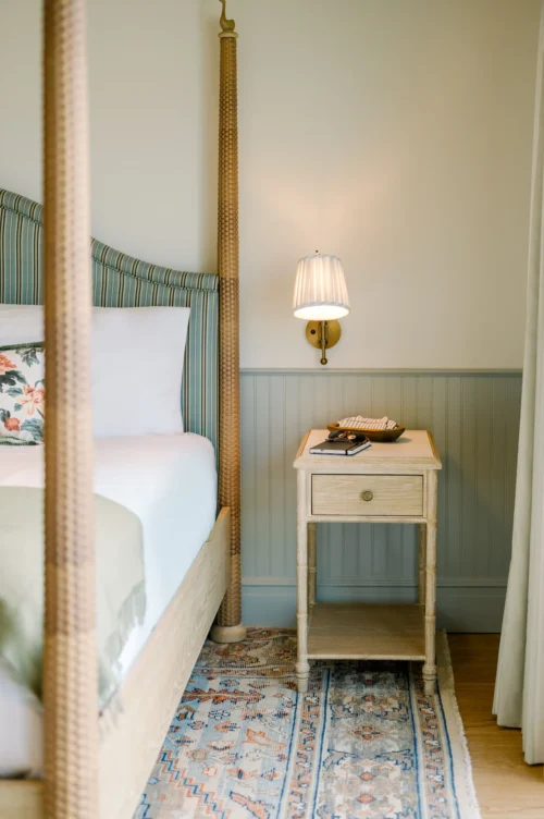 Nightstand with a cozy light next to the king-size bed in the suite at the Sanderling Hotel.