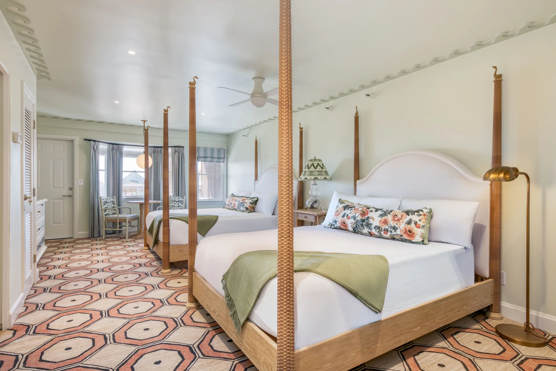 Beautiful and bright room with two queen beds, elegantly decorated with a blend of wood accents and geometric patterns.