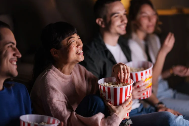 A cozy movie night at the Beach House Loft, where a group of friends enjoys a film together.