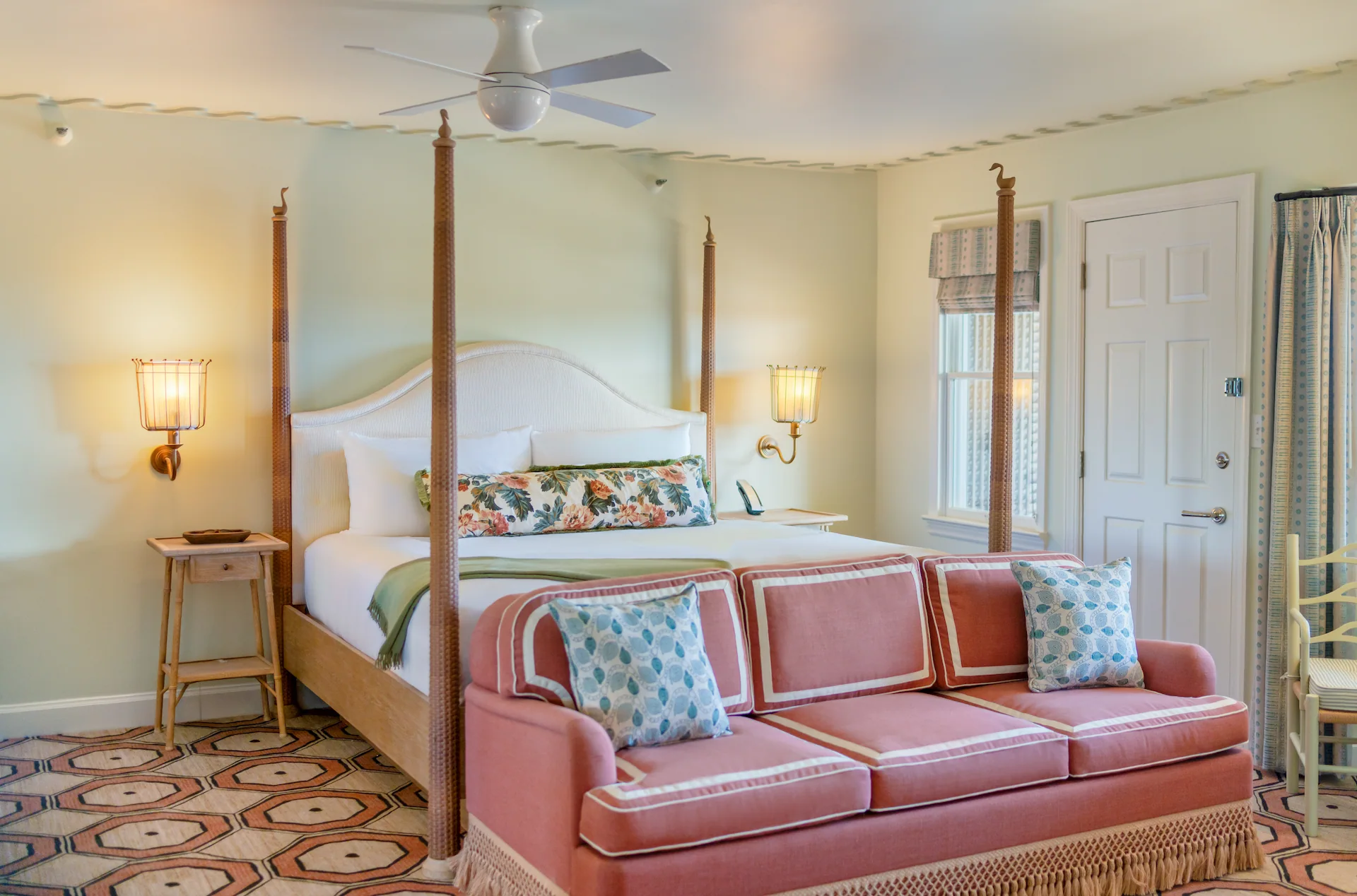 Room at The Sanderling Resort with warm lamps glowing and a burgundy sofa for relaxing.