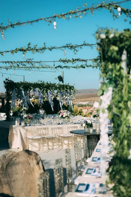 Beautifully set and decorated tables, awaiting a wedding celebration at The Sanderling Resort, surrounded by a floral atmosphere.