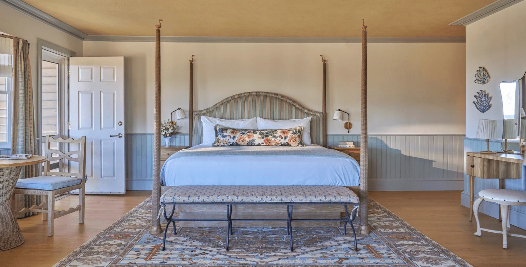 Spacious and bright room with light wood furniture and pastel blue tones, creating a homely atmosphere.